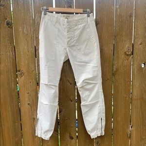 Nili Lotan white pants with jogger type hem and zippers. Big pockets